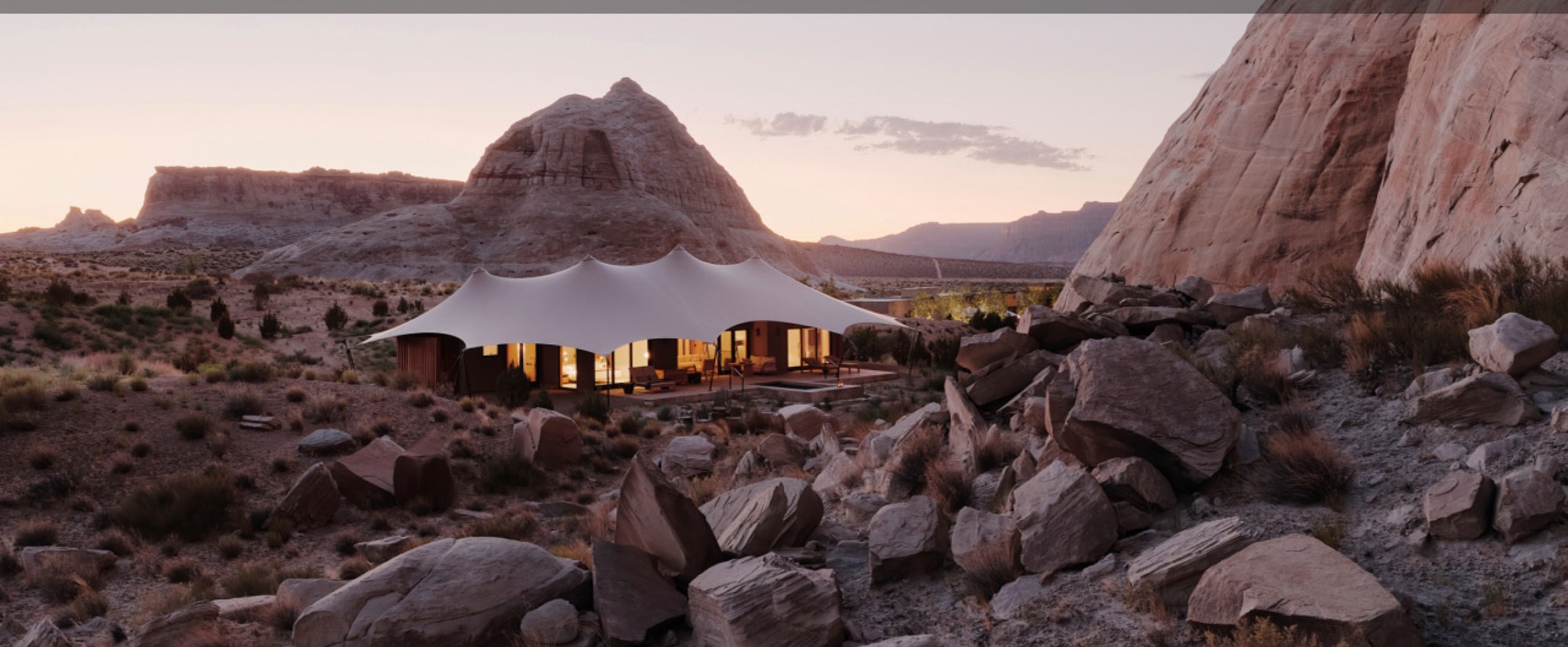 Tent lodge integrated into a rocky desert landscape